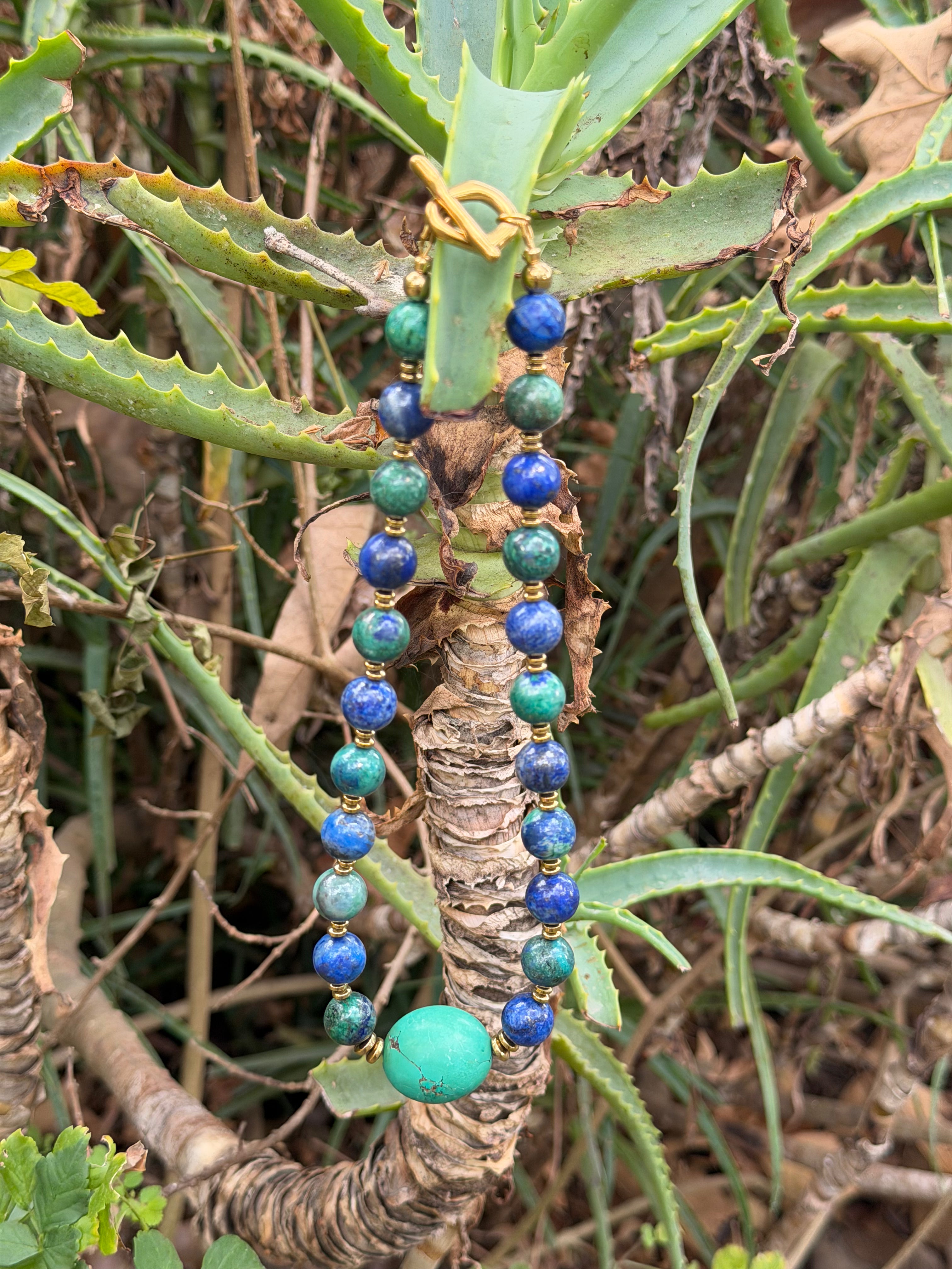 Handcrafted Phoenix Turquoise and Magnesite Turquoise beaded necklace displayed in natural outdoor lighting.⁠